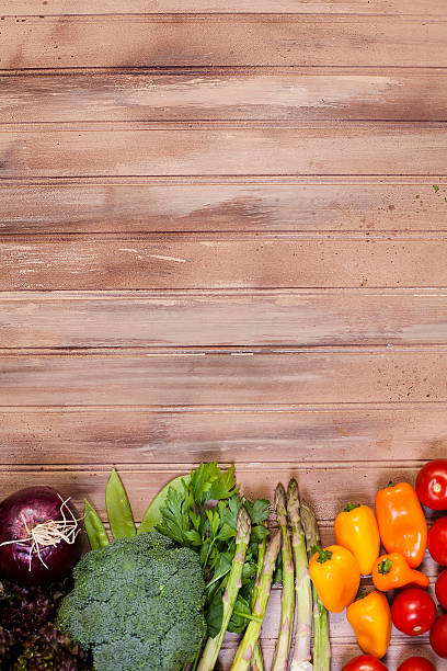 istock Fresh, organic colorful vegetables border rustic wooden table. 606015050