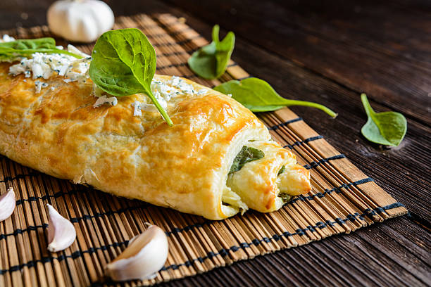 Strudel stuffed with spinach, cheese and garlic Savory strudel stuffed with spinach, Roquefort, Feta cheese and garlic strudel stock pictures, royalty-free photos & images