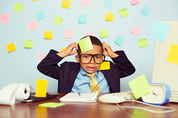 Young Businessman at Desk Covered with Blank Sticky Notes stock photo
