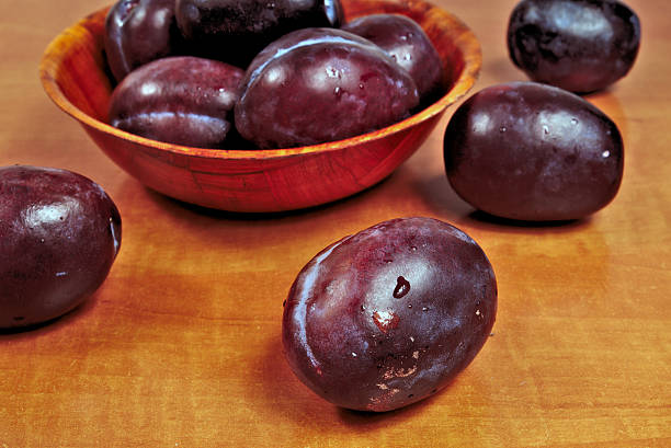 istock Ripe plums in a wooden bowl 606016566
