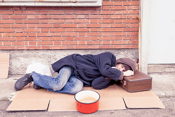 istock homeless sleeping on a cardboard in landfill 606017334
