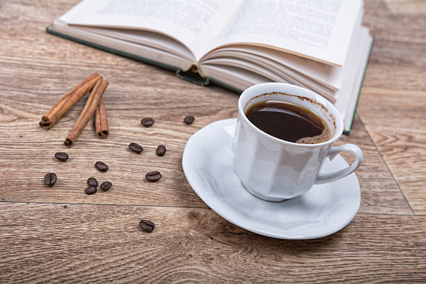 istock cup of coffee and cinnamon with a book 606017854