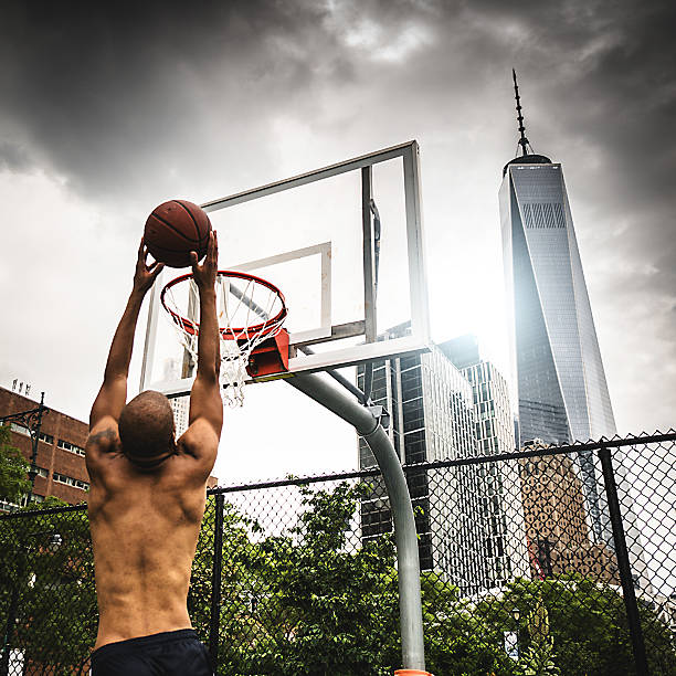 istock street basketball player doing a slam dunk 606018006