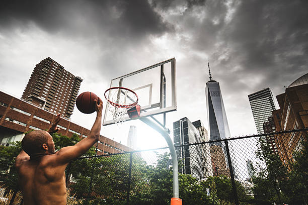 istock street basketball player doing a slam dunk 606018046