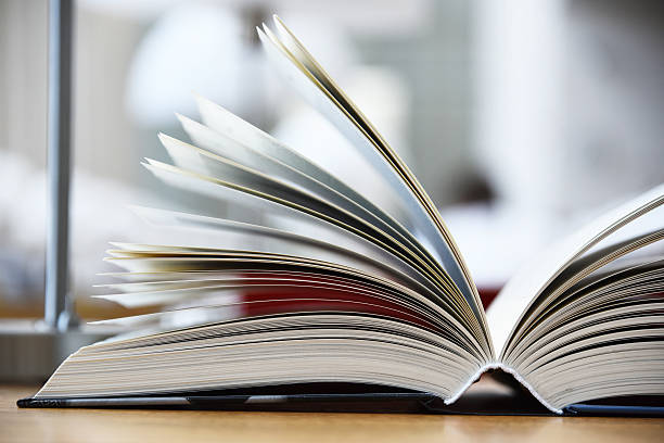 istock Hardcover book lying on the table in a library 606018490