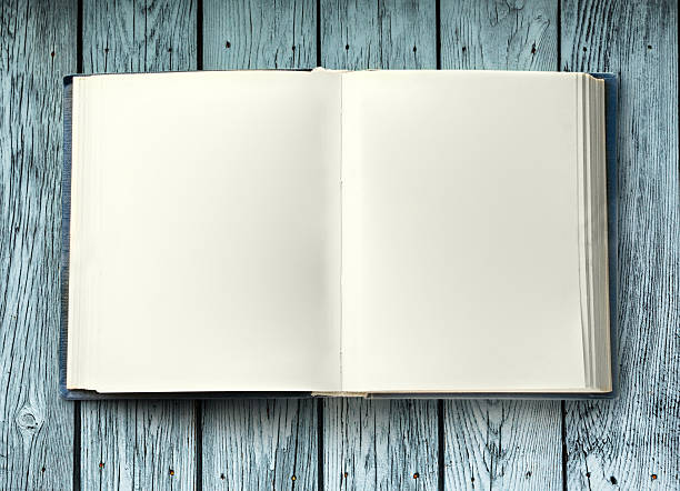 istock Open book on wooden background 606019002
