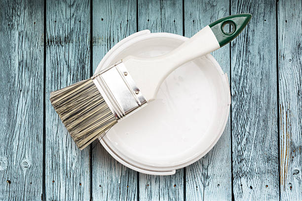 istock Open can of white paint with brush 606019548