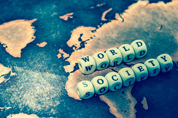 istock WORLD SOCIETY with magnifying glass on grunge world map 606191818