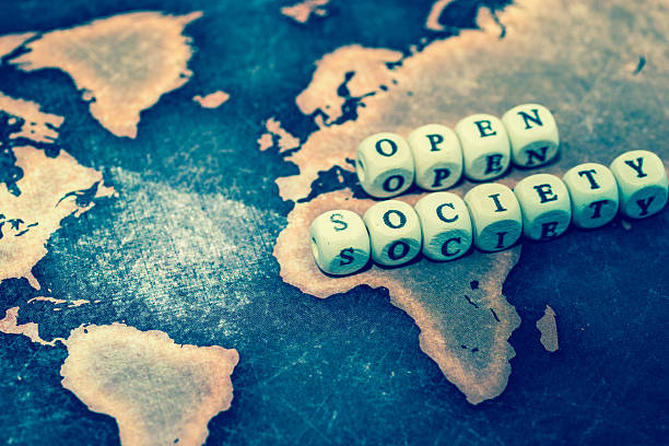 istock OPEN SOCIETY with magnifying glass on grunge world map 606191834
