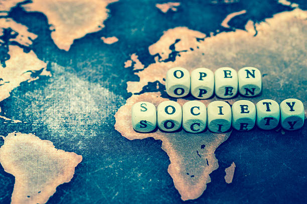 istock OPEN SOCIETY with magnifying glass on grunge world map 606191858