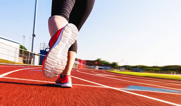 istock Woman jogging on a running track 606192142