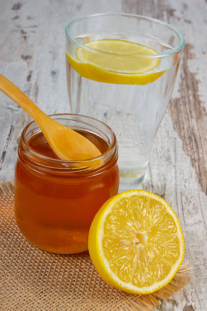 istock Fresh lemon with honey and glass of water 606199426
