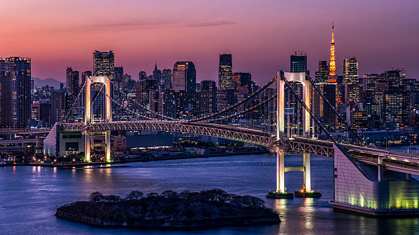 Rainbow bridge and Tokyo tower at dusk stock photo