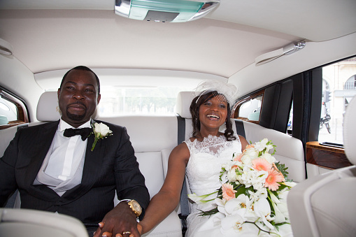 Newlywed african couple sitting in the car
