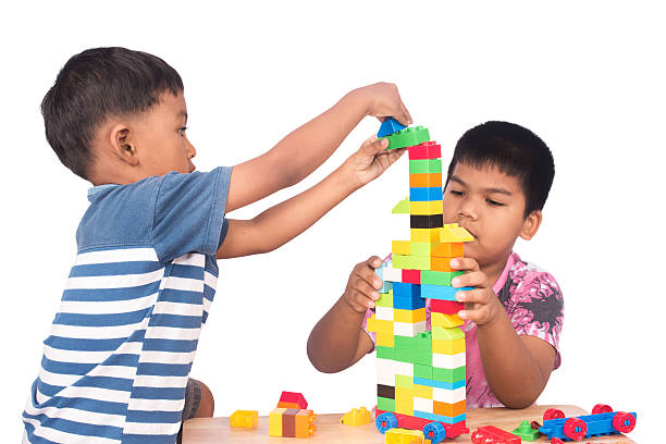 istock Two brother play building brick,focus little boy 606203960