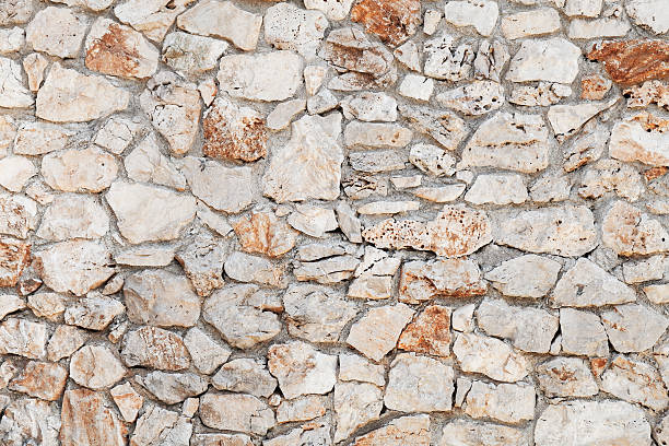 istock Rough outdoor stone wall background 606206422