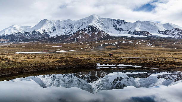 Mt. Animaqin with its reflection in water stock photo