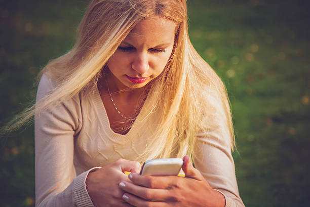 istock Young, beautiful woman reading a text on the mobile phone. 606207314