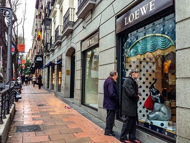 Madrid, Spain - December 27, 2013: Senior men looking at Loewe shop window display, Madrid
