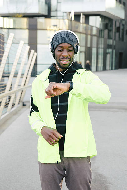 istock Cheerful Sport Man Looking At His Smart Watch 606210850