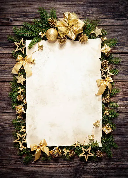 Photo of Old paper bordering with christmas decoration