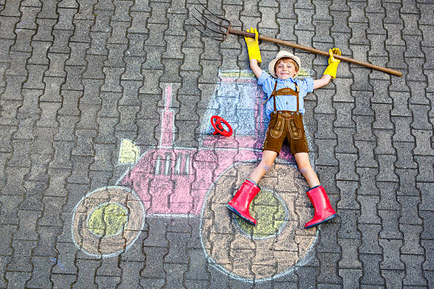 istock little kid boy having fun with tractor chalks picture 606212626
