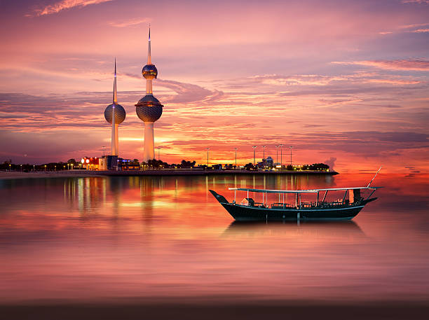 An old Arabian boat docked in front of Kuwait Landmark stock photo