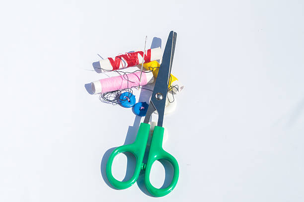 istock Spool of thread with needles and clippers on white background 606220406