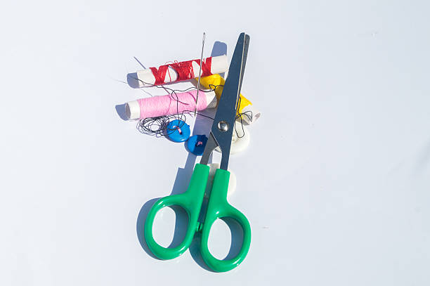 istock Spool of thread with needles and clippers on white background 606220488