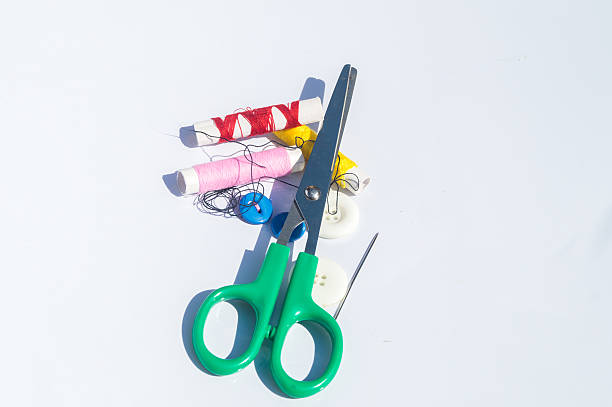 istock Spool of thread with needles and clippers on white background 606220560