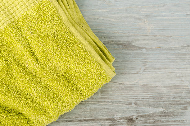 Bright textured abstract background from uneven surface of green towel
