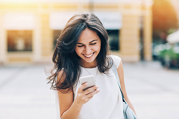 istock Attractive young woman with smart phone 606222880