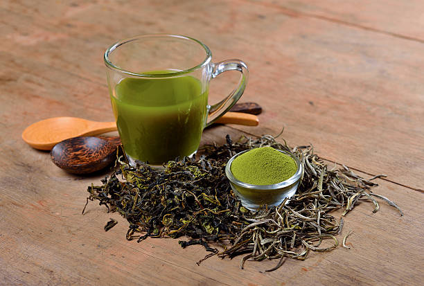 istock Dried tea leaf and powder with glass on wood 606223014