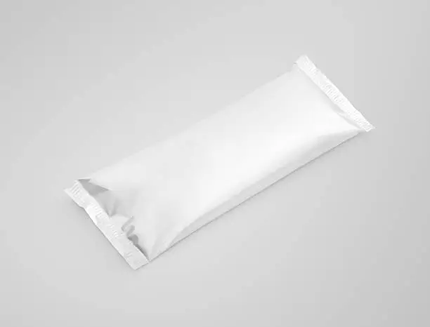 Photo of blank plastic pouch snack packaging on gray background