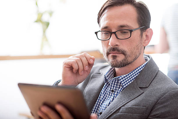 istock Handsome man working with help of laptop 606226368