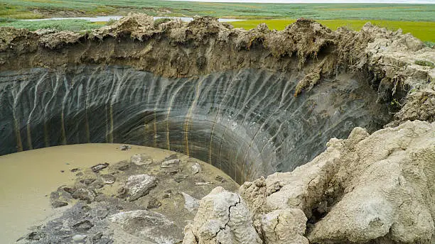 YAMAL PENINSULA, RUSSIA - JUNE 18, 2015: Helicopter expedition to the giant funnel of unknown origin. Crater view.