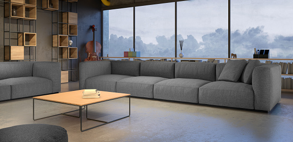 Living room with large windows. Gray sofa couch, shelfs, music instrument, coffee table. Modern design with many details. Colors in the scene are predominantly gray with dark ambiance. Spotlights lit the scene. Horizontal composition.