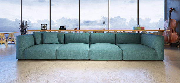 Living room with large windows. turquoise sofa, shelfs, music instrument in the background. Modern design with many details.  Spotlights lit midnight scene. Horizontal wide letterbox composition.