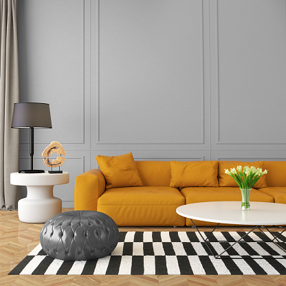 Square composition showing modern eclectic living room with orange sofa, gray cushion stool, with ornate elements around. Striped black and white carpet over a parquette floor, a lamp, flowers in a glass vase, with classic wall with ornate elements. 3D render