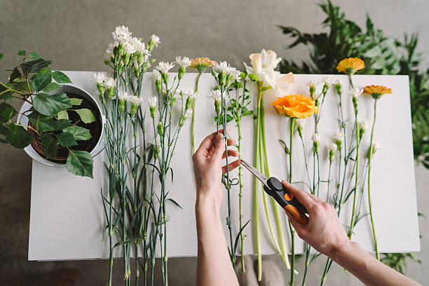 istock Florist workspace: young caucasian woman making floral decorations 606228704