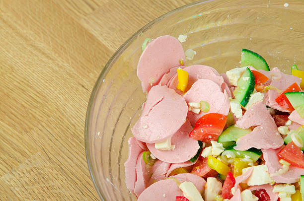 A original Austrian Wurstsalat in a bowl. Wurstsalat, also known as sausage salad. It is a very delicious meal from the Austrian, German and also Swiss cuisine.