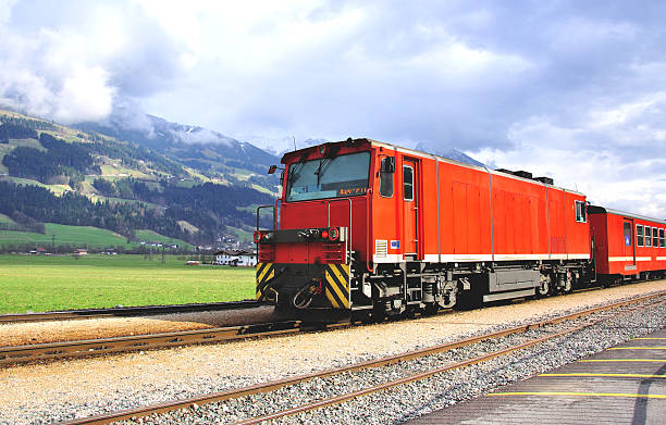 istock Old fashioned red train goes through the austrian Alps 606230494