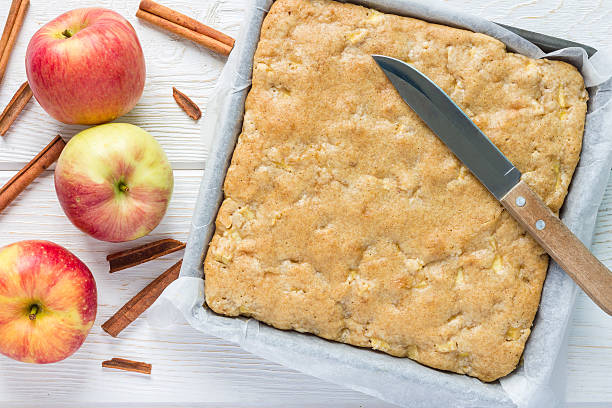 Homemade blondie brownies apple cake in baking dish, top view Homemade blondie (blonde) brownies apple cake in baking dish, horizontal, top view blondy stock pictures, royalty-free photos & images