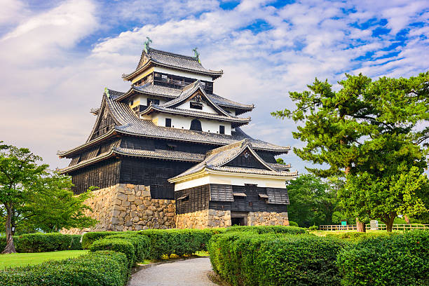 Matsue, Japan - August 29, 2015: The keep of Matsue Castle from the entrance gate. The castle has one of the few original castle keeps remaining in the country.