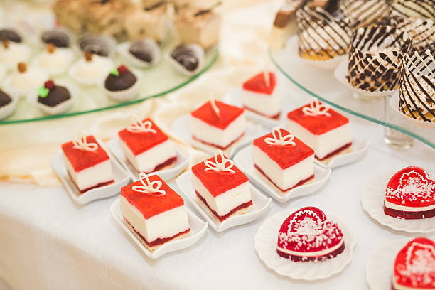 Delicious and tasty dessert table with cupcakes and shots at reception closeup.