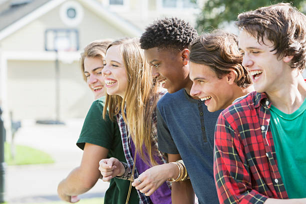 istock Group of five multi-ethnic teenagers hanging out 606236348