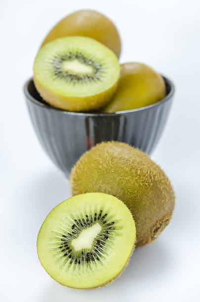 istock kiwi fruit and half with black bowl 606237908