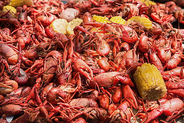 istock Crawfish, corn and potatoes on table at crawfish boil 606238548