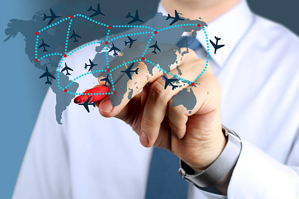 istock Young business man drawing an airplane routes on world map. 606238856