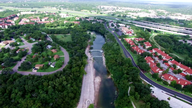 Aerial: Georgetown Texas Aerial Fly By Over San Gabriel River Apartments Hill Country Town